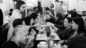 Black and white photo of people eating