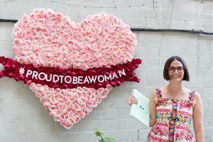 Maya in front of Large Heart Made of Roses